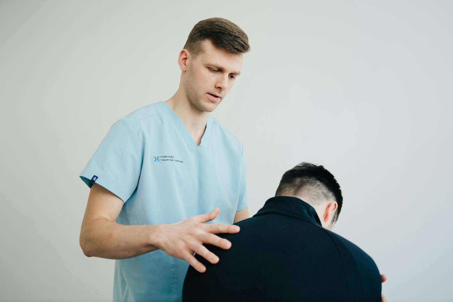 physiotherapist standing over patient